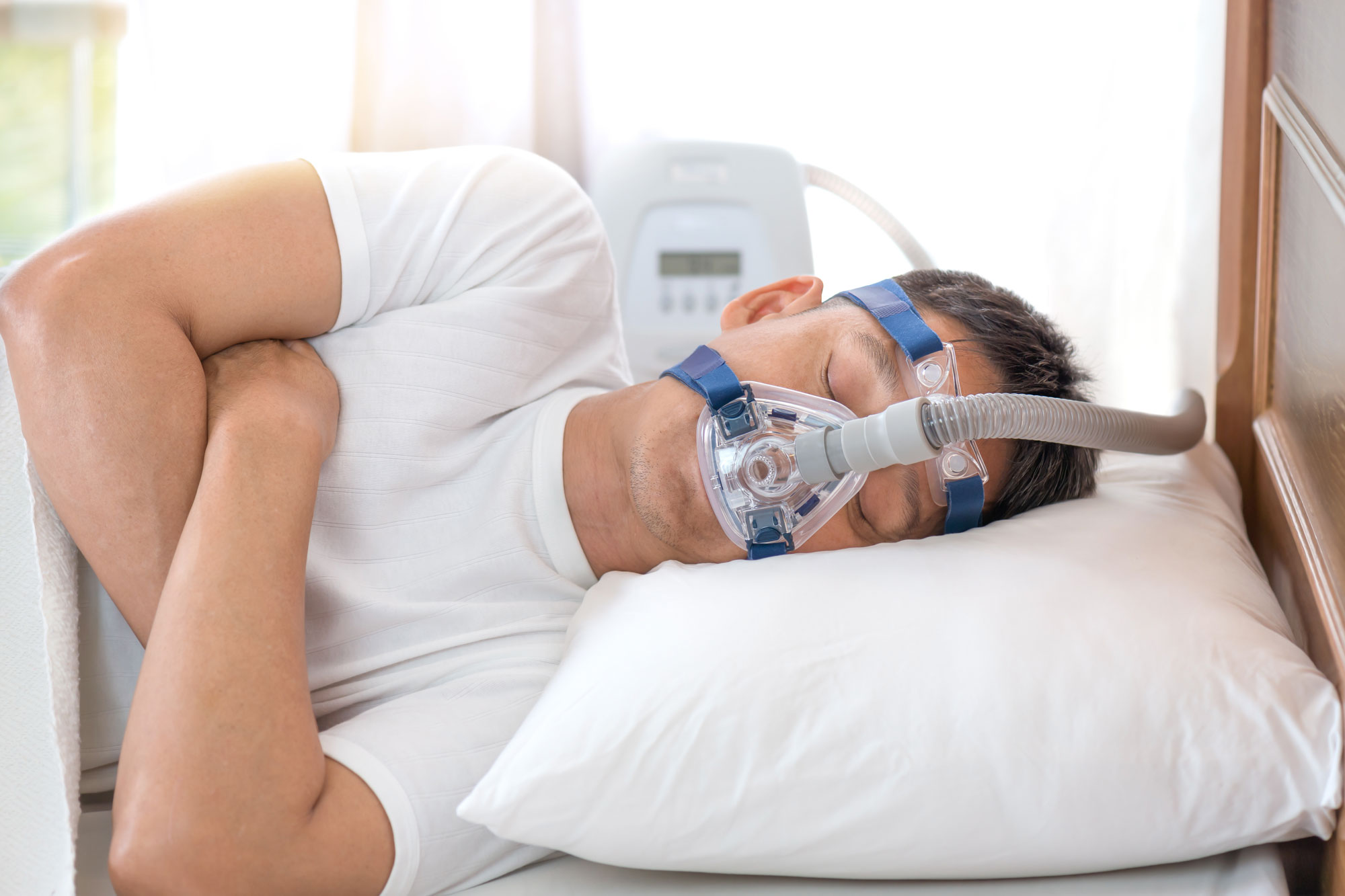 man sleeping on side with breathing mask